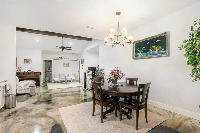 a view of a dining room with furniture and chandelier