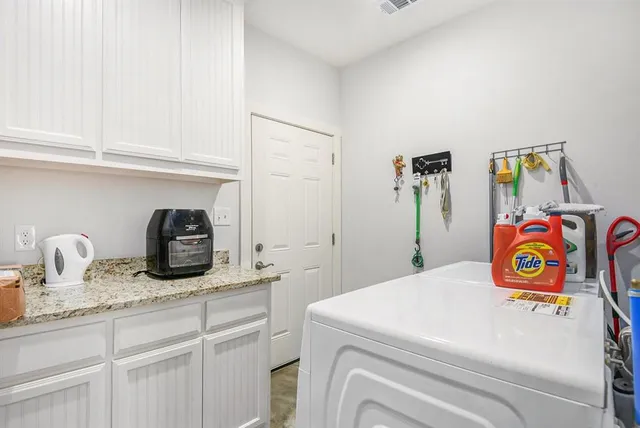 a utility room with faucet dryer and washer