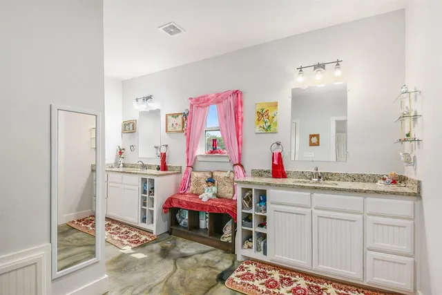 a room with kitchen island a sink and a refrigerator