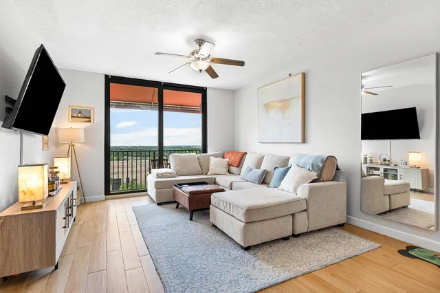 a living room with furniture and a wooden floor