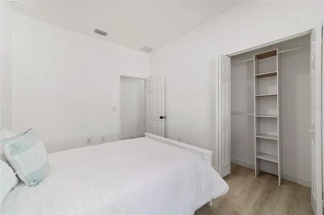 a bedroom with a bed and a closet