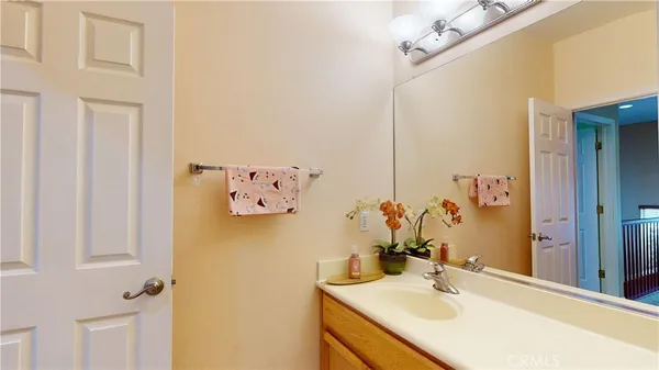 a bathroom with a sink vanity and a mirror