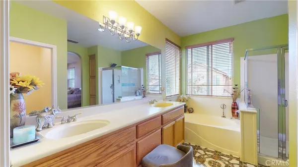 a bathroom with a tub a sink and a large mirror