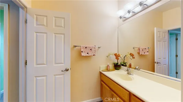a bathroom with a sink vanity and a mirror