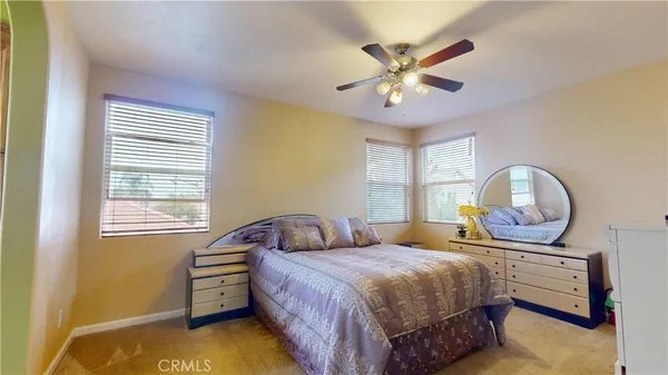 a bedroom with a bed window and dresser