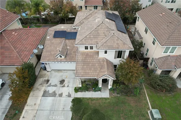 an aerial view of residential houses with outdoor space and trees