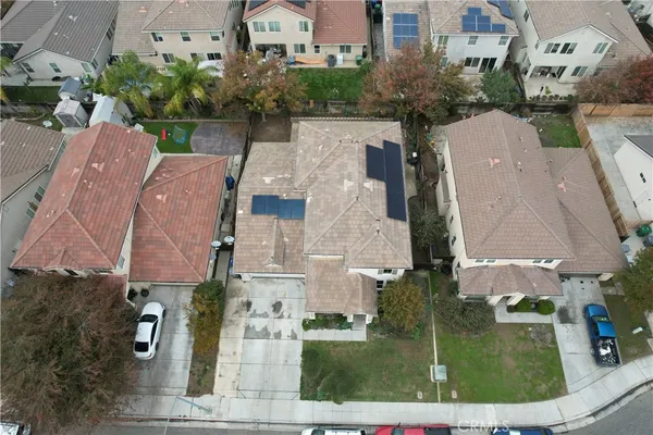 an aerial view of residential houses with outdoor space and parking