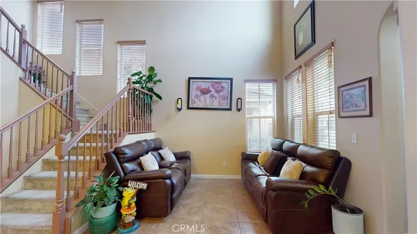 a living room with furniture and a potted plant