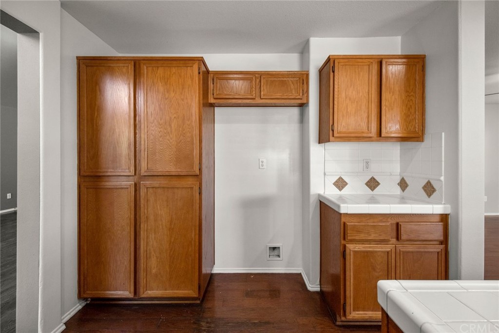 28346 Saddlecrest Street Menifee, CA 92585 - Photo 12 of 35 a hallway view with wooden floor and cabinet