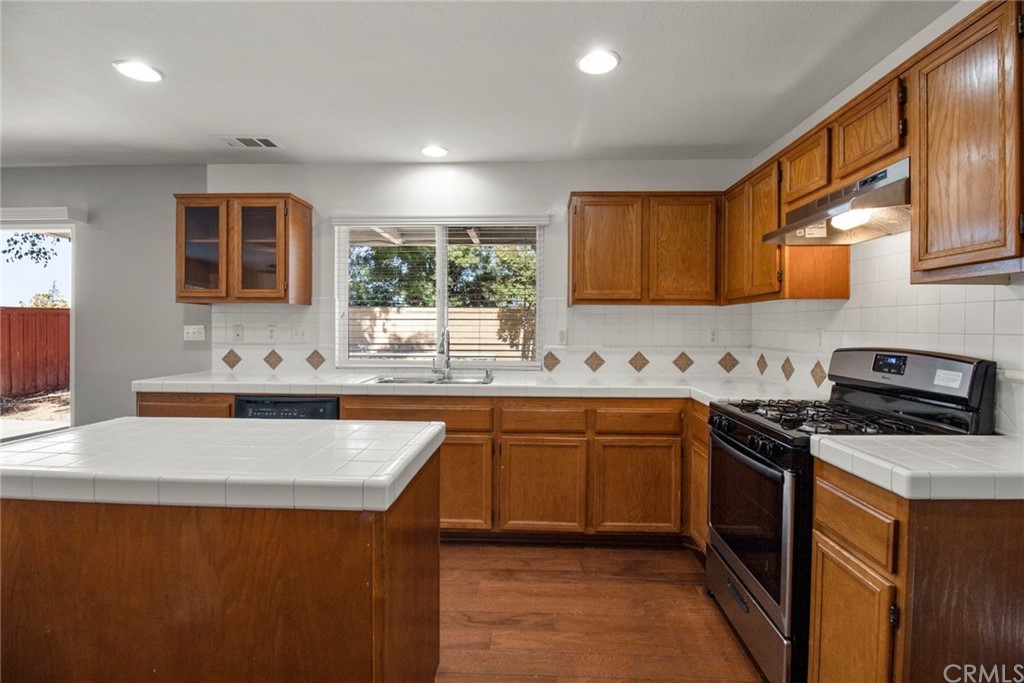 28346 Saddlecrest Street Menifee, CA 92585 - Photo 13 of 35 a kitchen with stainless steel appliances granite countertop a sink stove and refrigerator