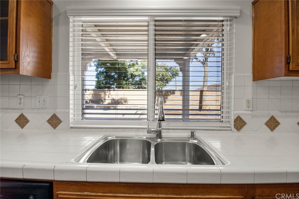 28346 Saddlecrest Street Menifee, CA 92585 - Photo 14 of 35 a kitchen with a sink and a window