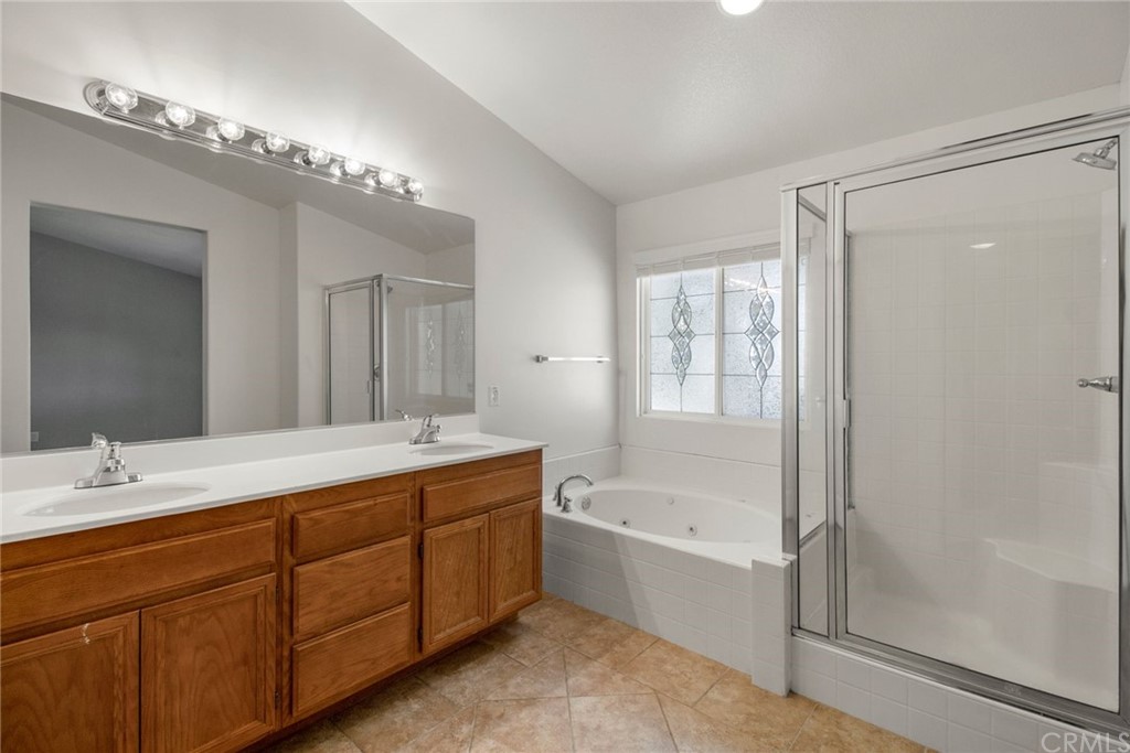 28346 Saddlecrest Street Menifee, CA 92585 - Photo 18 of 35 a bathroom with a tub sink shower and mirror