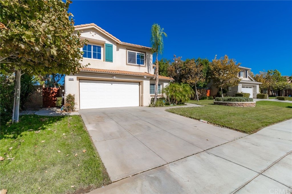 28346 Saddlecrest Street Menifee, CA 92585 - Photo 3 of 35 a front view of a house with a yard and garage