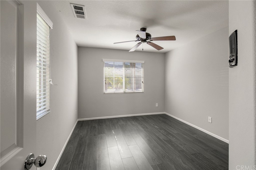 28346 Saddlecrest Street Menifee, CA 92585 - Photo 21 of 35 wooden floor in an empty room with a window