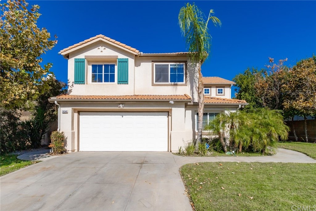 28346 Saddlecrest Street Menifee, CA 92585 - Photo 4 of 35 a front view of a house with a yard and garage