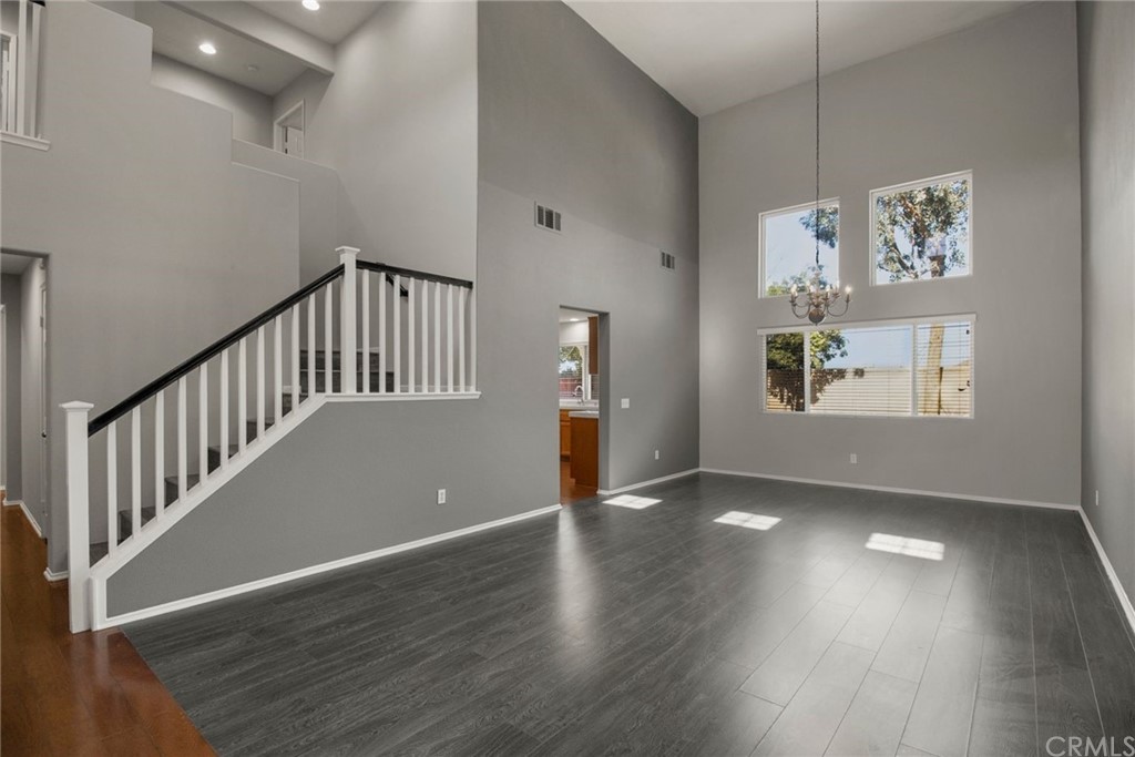 28346 Saddlecrest Street Menifee, CA 92585 - Photo 7 of 35 a view of an empty room with wooden floor and a window