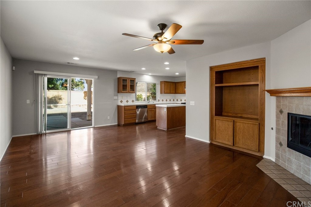 28346 Saddlecrest Street Menifee, CA 92585 - Photo 9 of 35 a view of a kitchen with a stove cabinets wooden floor and a kitchen
