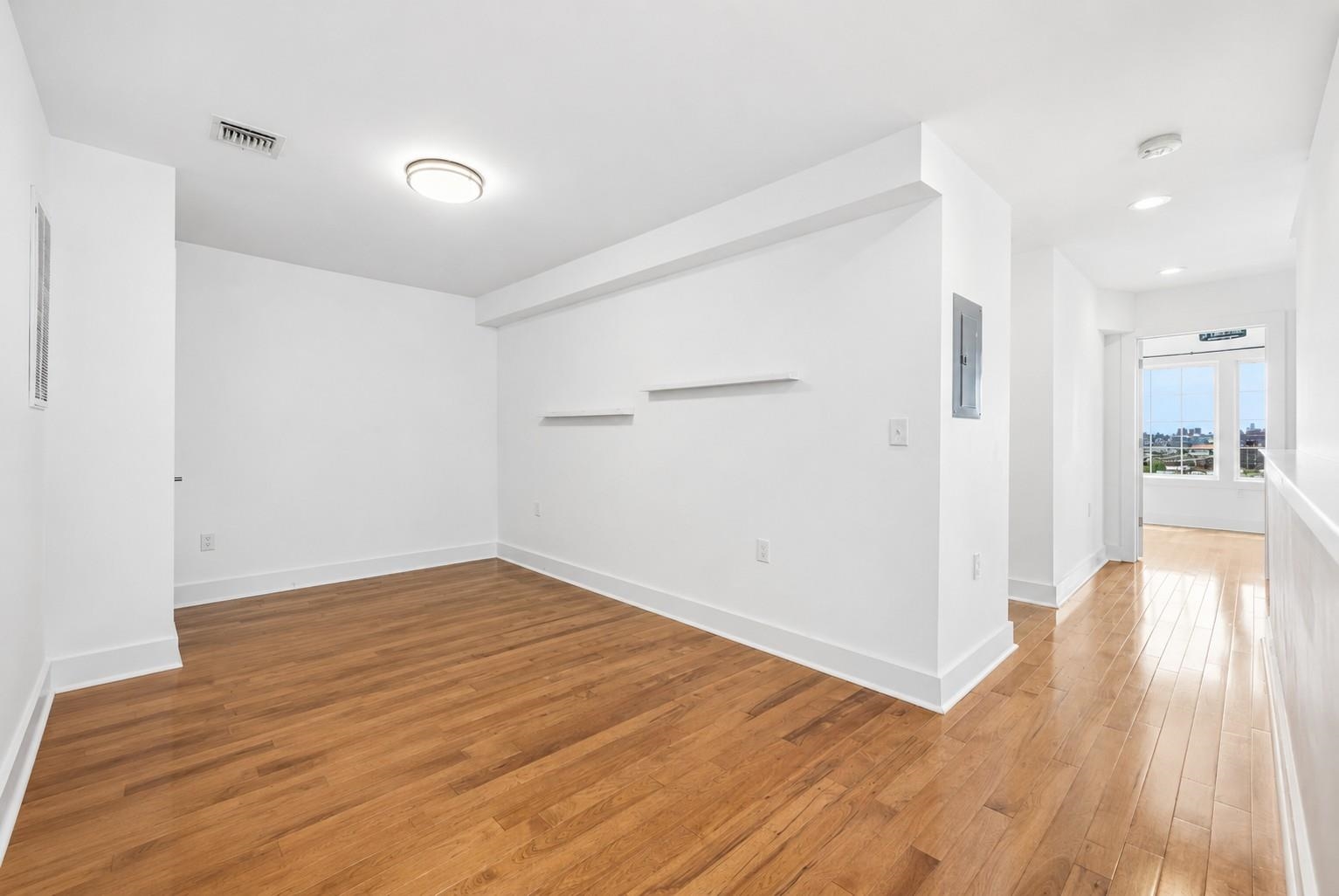 107 Mountain Road Jersey City, NJ 07307 - Photo 29 of 41 wooden floor in an empty room with a window