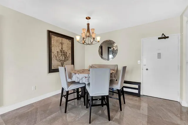 a view of a dining room with furniture and a chandelier