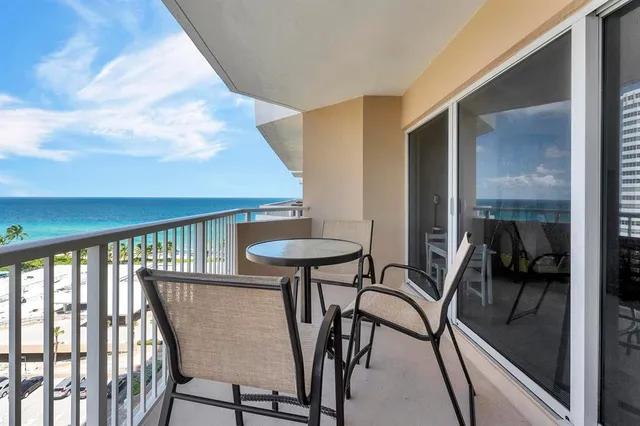 a view of a room with furniture and a table