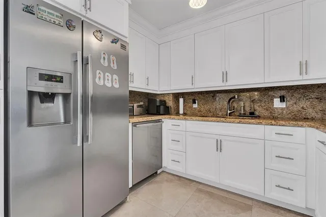 a kitchen with cabinets and stainless steel appliances