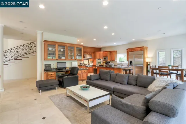 a living room with furniture and view of kitchen