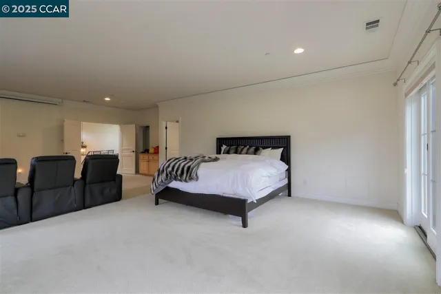 a spacious bedroom with a bed and furniture