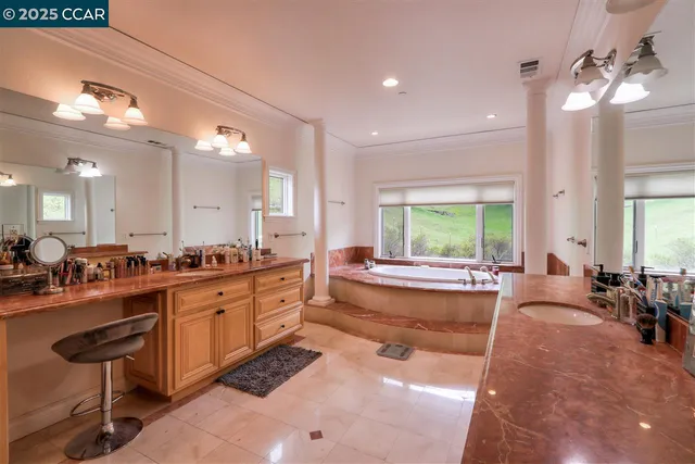 a large spacious bathroom with a large tub and sink