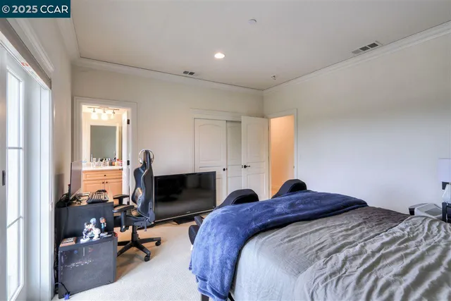 a bedroom with a bed and a tv