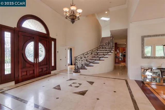 a view of a livingroom with furniture staircase and front door