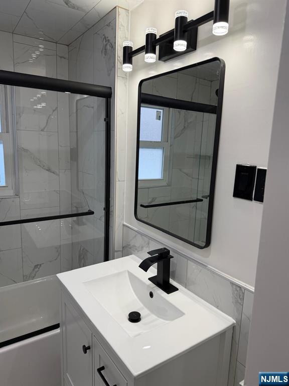 20 Maple Street Ridgefield Park, NJ 07660 - Photo 19 of 22 a bathroom with a sink a mirror and vanity