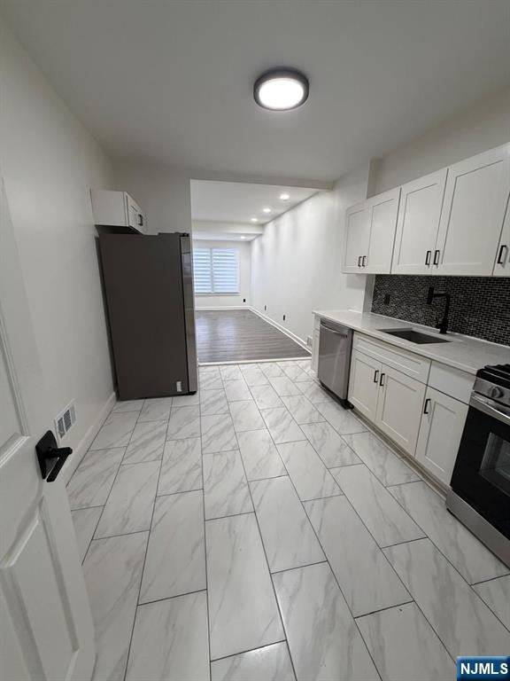 20 Maple Street Ridgefield Park, NJ 07660 - Photo 2 of 22 a view of a kitchen with electric appliances