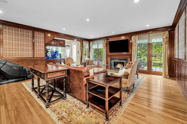 a living room with furniture a flat screen tv and a large window