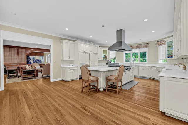 a large kitchen with a table and chairs in it