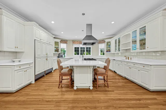 a kitchen with stainless steel appliances kitchen island granite countertop a sink and cabinets