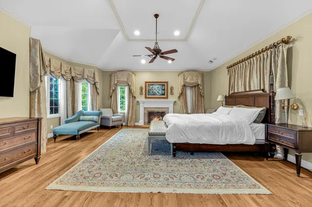 a living room with a couch dresser and wooden floor