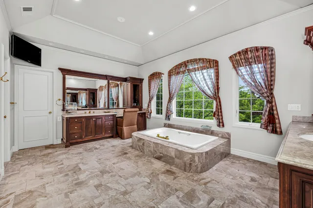 a large spacious bathroom with a large tub and sink
