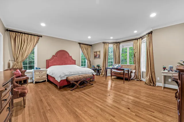 a spacious bedroom with a large bed and a large window