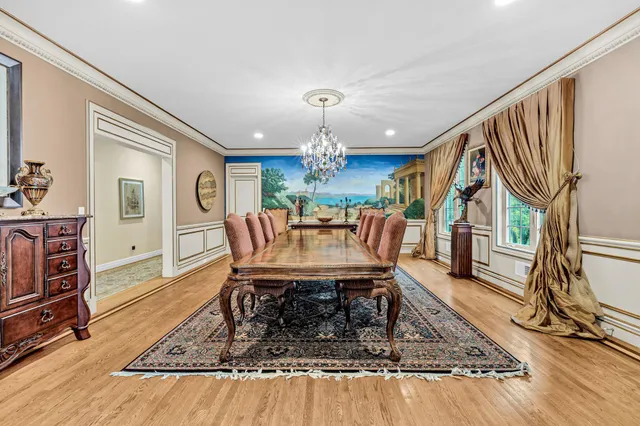 a living room with furniture a rug and a chandelier