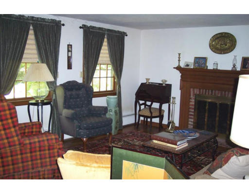 223 Middle Road Newbury, MA 01922 - Photo 5 of 10 a living room with furniture and a fireplace