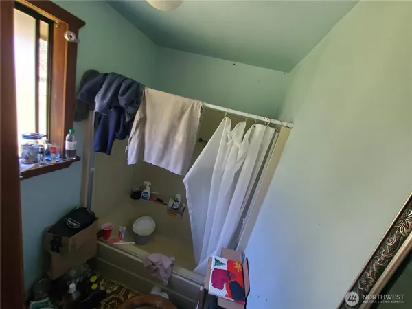 a bathroom with a sink toilet and window