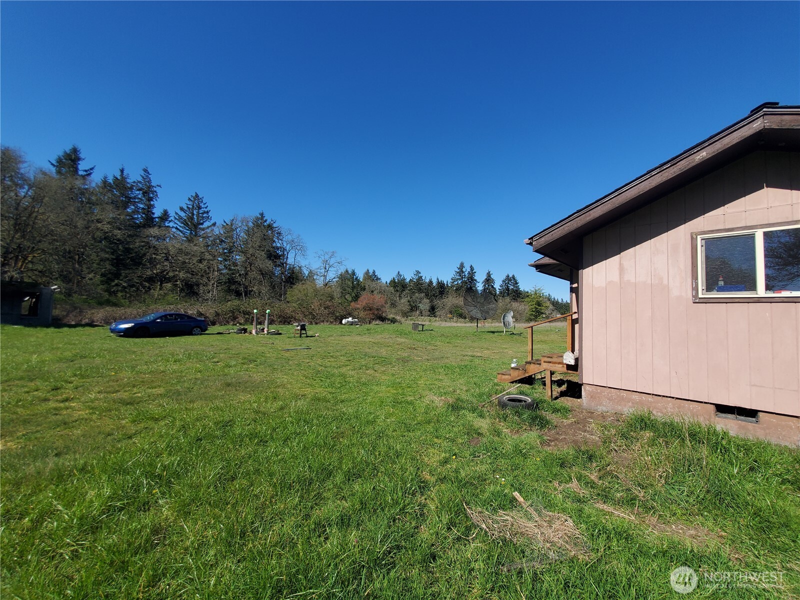 4924 165th Lane Southwest Rochester, WA 98579 - Photo 19 of 27 a view of a backyard with plants and a garden