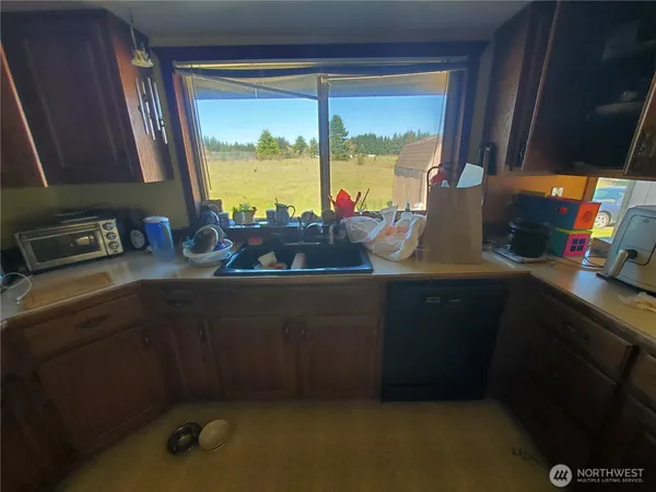 a kitchen with a sink and a window