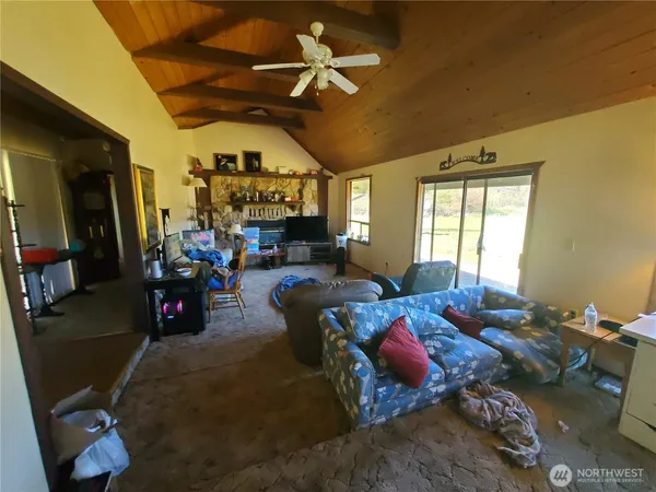 a living room with furniture fireplace and a window