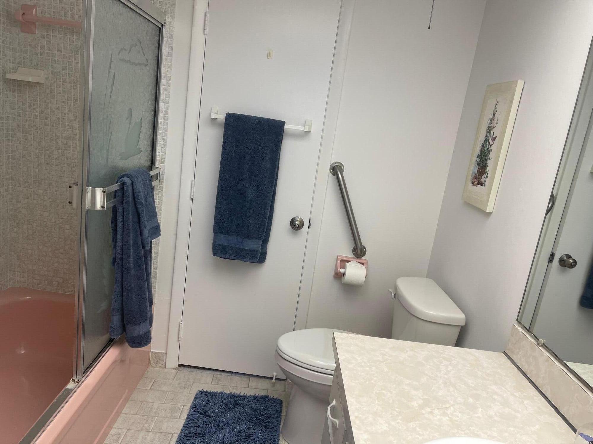 117 Lake Terrace, Unit F208 Boynton Beach, FL 33426 - Photo 21 of 30 a white toilet sitting next to a bathroom sink