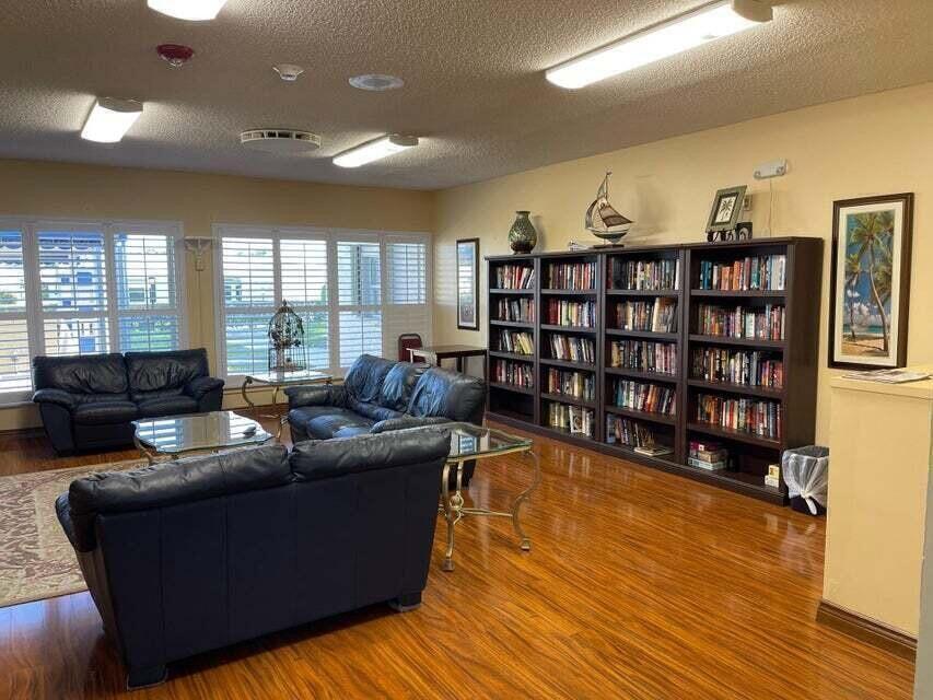 117 Lake Terrace, Unit F208 Boynton Beach, FL 33426 - Photo 27 of 30 a living room with furniture and a book shelf