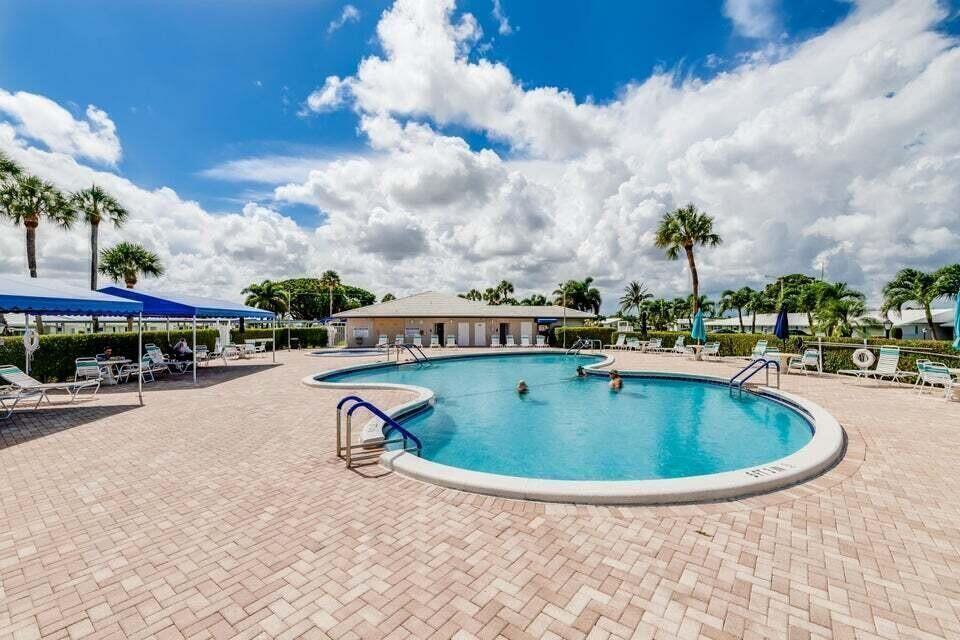117 Lake Terrace, Unit F208 Boynton Beach, FL 33426 - Photo 3 of 30 a view of swimming pool with outdoor seating and buildings in the background