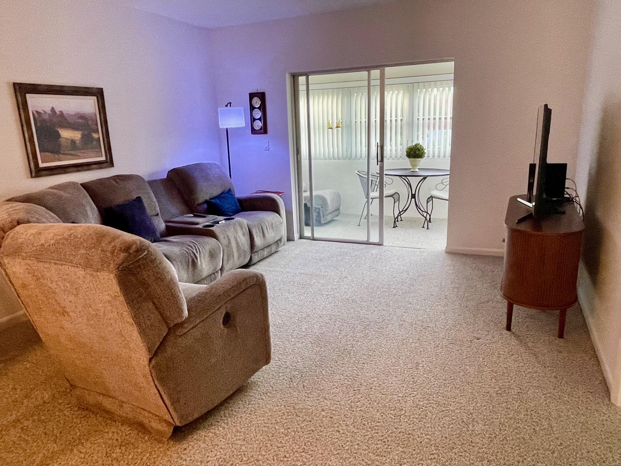 117 Lake Terrace, Unit F208 Boynton Beach, FL 33426 - Photo 7 of 30 a living room with furniture and a flat screen tv