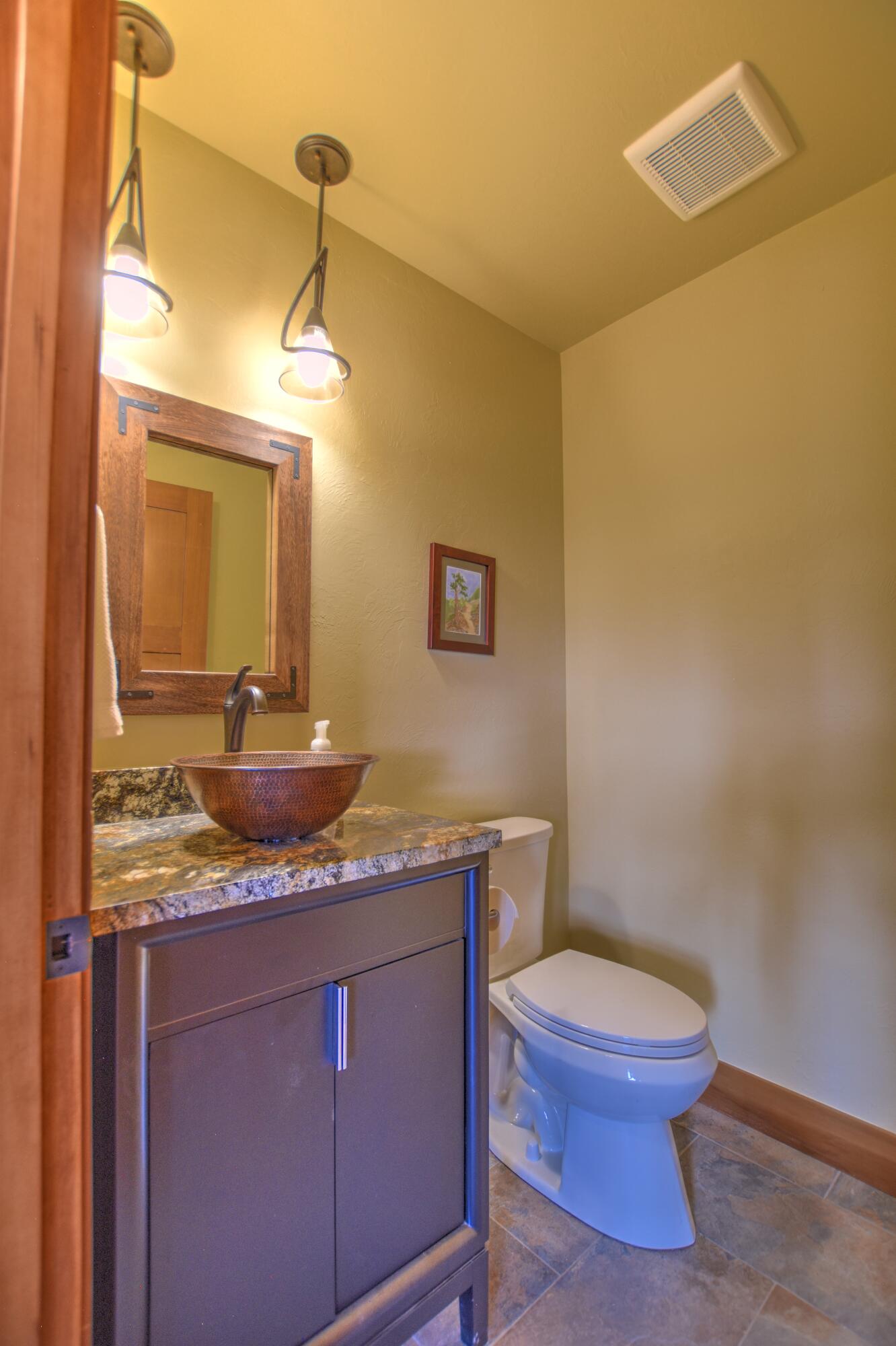 10 Valley View Road Ridgway, CO 81432 - Photo 15 of 33 a bathroom with a granite countertop toilet sink and mirror