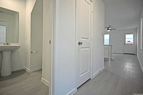 a view of a hallway with wooden floor